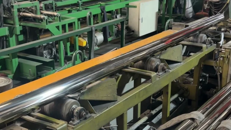 Polished stainless steel tubes on a surface finishing production line
